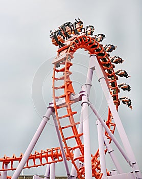 People ride on roller Coaster