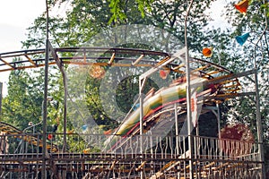 People ride on a roller coaster in an amusement park