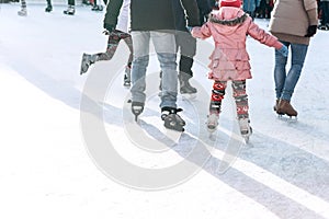 People ride on the skating rink on the ice rink during the Christmas holidays.