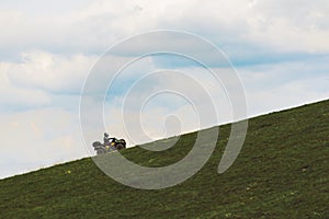 people riding on all terrain vehicle by mountains