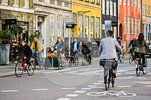 People riding bicycles Copenhagen old town, Denmark. Street style