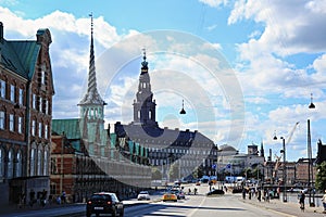 People riding bicycles on a street in Slotsholmen, view on a famous Old Stock Exchange -BÃÆÃÂ¸rsen. The tower with 