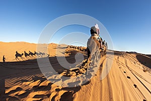 People riding camel in the Sahara desert, Morocco