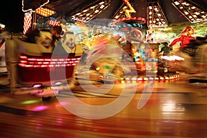 People riding carnival ride at night