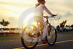 People riding exercise bikes at the park in the evening