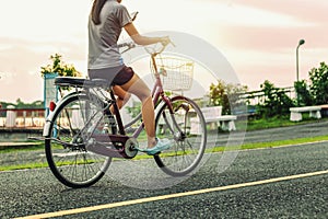 People riding exercise bikes at the park in the evening