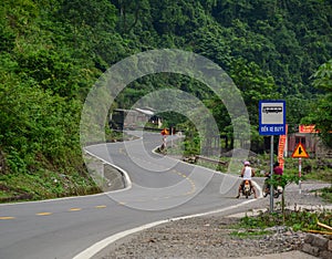 People riding motorbikes on rural road in Lang Son, Vietnam