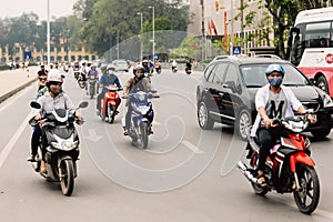People riding motorcycles on the road at Hanoi, Vietnam