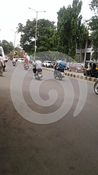 People riding motorcycles on the road