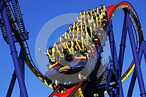 People riding roller coaster