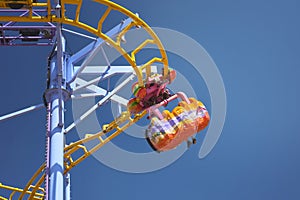 People riding on a roller coaster at an amusement park