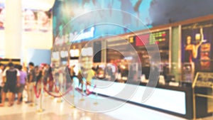 People in row buy the movie ticket at cinema ticket counter, blur background