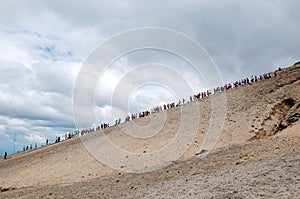 People in a row climb mountains