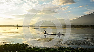 People rowing boat on lake in Srinagar, India