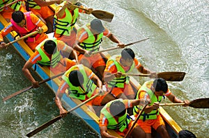 People rowing dragon boat in racing