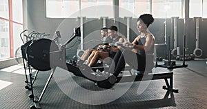 People, rowing machine and gym workout for exercise challenge or fitness teamwork, friends or cardio. Men, woman and