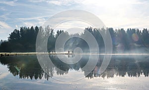 people run in forest near zeewolde in dutch province of flevoland along water of pond in autumnal forest