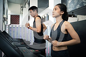 People running in machine treadmill at fitness gym