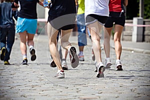 People running in marathon on city street