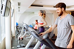 People running on treadmill in gym