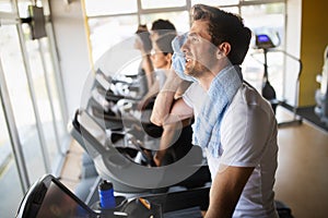 People running on treadmill in gym doing cardio workout