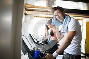 People running on treadmill in gym doing cardio workout