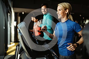 People running on treadmill in gym doing cardio workout