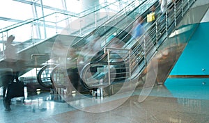 People rush on escalator motion blurred