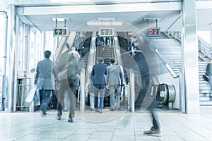 People rush on a escalator motion blurred