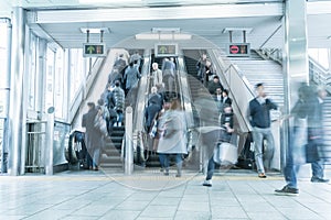 People rush on a escalator motion blurred