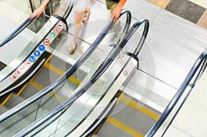 People rush on escalator motion blurred