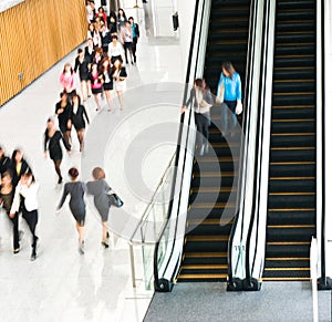 People rushing on escalator photo