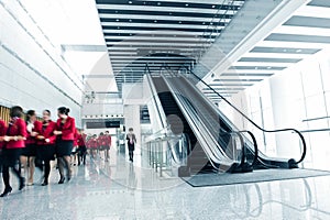 People rushing on escalator