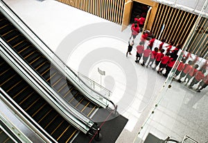 People rushing on escalator