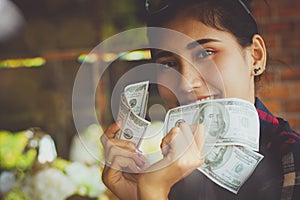 People`s hands holding US dollars banknotes with happy.