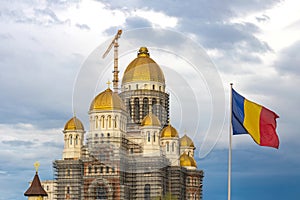 People\'s Salvation Cathedral under construction in Bucharest, with Romanian flag waving in next to it.