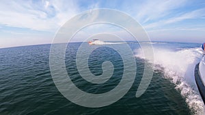 People sailing in motor boat on sea on sunny summer day.