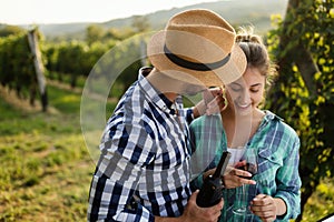 People sampling and tasting wines in vineyard