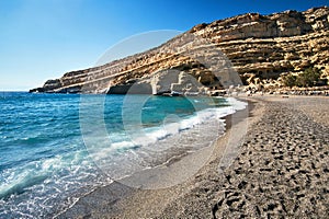 People on the sandy Matala beach on the island of Crete