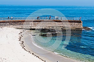 People on Sea Wall Overlooking La Jolla Children`s Pool