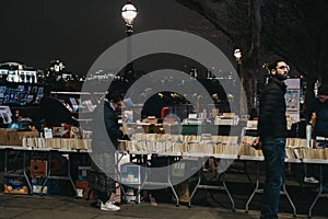 People at second hand book market in Southbank, London, in the evening