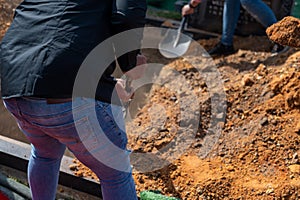 People seen filling grave site