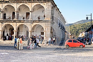 People are seen walking the cobble stone roads by the main Plaza of Antigua, Guatemala. Central America