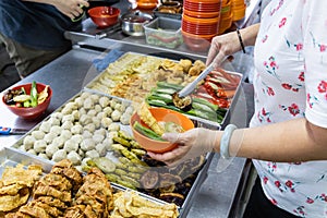 People selecting yong tau foo, delicious fried stuffed fish paste into chilli pepper, okra, aubergine, bean paste and