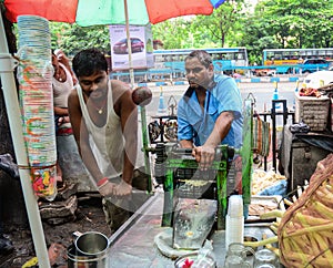 People selling sugarcane juice at market in Kolkata, India