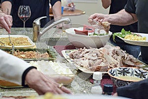 People serving themselves Thanksgiving dinner