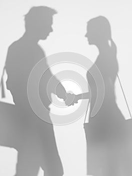 People shaking hands, silhouette