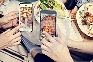 People sharing food photos on mobile phone