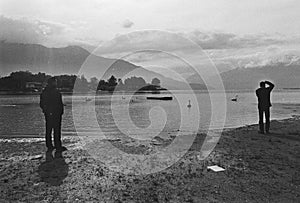 People shooting on Lake of Como, Film frame, black and white analog camera