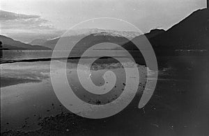 People shooting on Lake of Como, Film frame, black and white analog camera